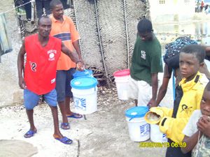 Distribution of hope for haiti survival buckets|Strong winds and flash flooding.|Flooding in aquin.|Housing under water.