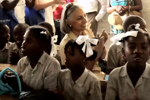 JoAnne Founder with Children singing